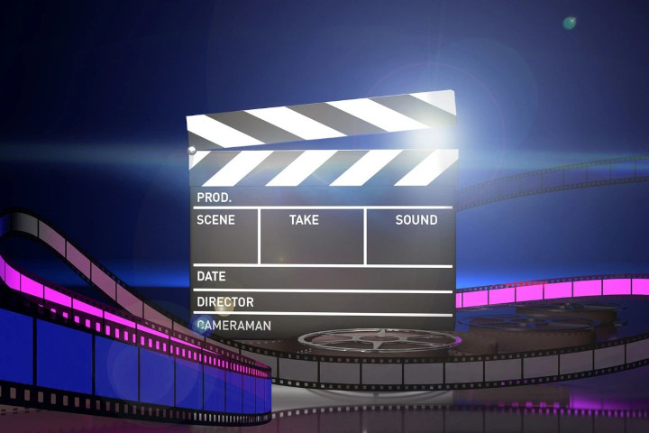 A large movie screen with the words " press scene take sound ".